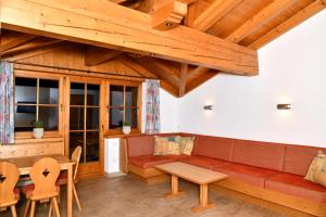 a living room with a couch and a table at Appartements neben der Gondelbahn - Haus Süd in Brixen im Thale