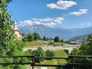 a view of a road with mountains in the background at Artemisia in Roisan