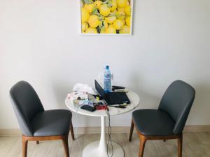 two chairs and a table with a laptop on it at Luxury studio apartment near Nha Trang beach in Nha Trang