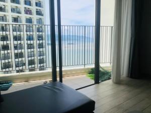 a room with a balcony with a view of the ocean at Luxury studio apartment near Nha Trang beach in Nha Trang