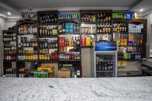 uma loja cheia de garrafas de álcool em GLAMOUR APOLLO HOTEL em Webuye