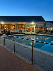 a large swimming pool in front of a building at Rydal Retreat Lakeland Holiday Park in Flookburgh