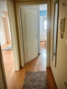 奥赫里德SM Apartment Center的一条带白色门和地毯的走廊