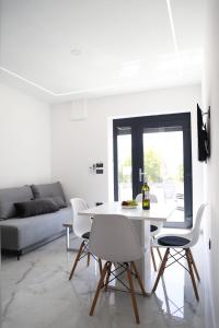 a white dining room with a white table and chairs at Elite estate in Podstrana