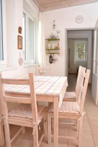 a dining room table with two chairs and a table at DIVADELNÍ PENZION 