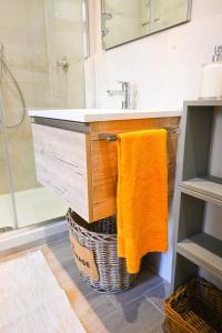an orange towel hanging under a bathroom sink at Casa Pesa 2 rooms 2 baths Rome center in Rome