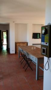 a kitchen with a wooden table in a room at Il Giardino nell'Orto in Vetralla