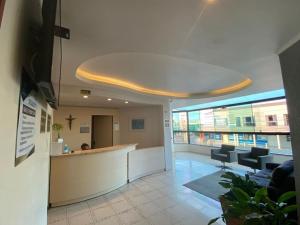 an office lobby with a reception desk and chairs at Hotel Blanner in Charqueadas