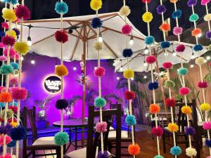 a group of colorful pom poms hanging from a tent at Llaqta Wasi in Lima