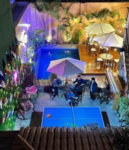 a group of people sitting at tables with umbrellas at Llaqta Wasi in Lima