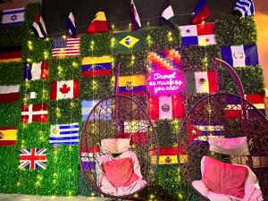 a display of flags and chairs inront of christmas trees at Llaqta Wasi in Lima