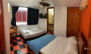 a small bedroom with two beds and a window at Hotel Bahia Plaza in Santa Marta +56 photos