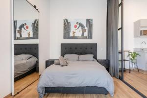 1 dormitorio con 1 cama grande y 2 espejos en Kasa Nápoles, en Ciudad de México