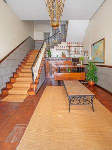 a lobby with stairs and a table and a bench at Porto Je T'aime - Solar São João in São João da Madeira