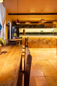 a restaurant with two wooden benches and a bar at Pousada Carioca - Pousada de Charme in Jericoacoara