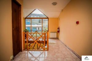 a hallway with a glass door to a balcony at Hostería Bella Ushuaia in Ushuaia