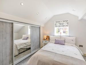 a bedroom with a bed and a mirror at Goosehill Fold in Normanton