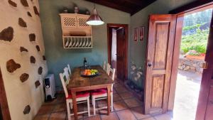 a kitchen with a table with a bowl of fruit on it at Federico in Puntagorda