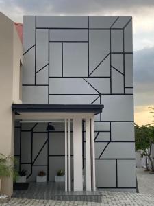 a building with a black and white facade at Knightsbridge Hotel & Suites in Abuja