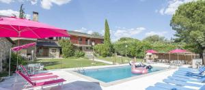 a swimming pool with a pink flamingo in front of a house at La Pedriza in Galapagar