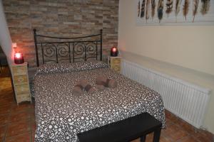 a bedroom with a bed with two shoes on it at La Pedriza in Galapagar