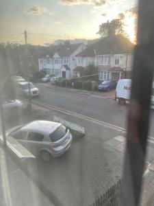 a car parked on a city street in the rain at Edgware Rooms in Stone Grove