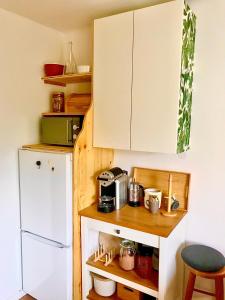 a small kitchen with a white refrigerator and a counter at Stadtoase mit traumhaftem Ausblick in Linz
