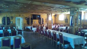 a dining room with tables and chairs in a building at Motel Lovac in Štrpce