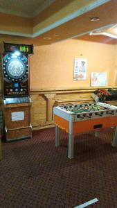 a room with a pool table and a large video screen at Lovac in Štrpce