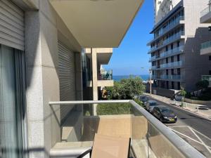 a balcony of a building with a view of a street at Relax Sea View 3BR in Gordon Beach by Holyguest in Tel Aviv