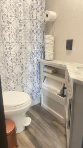 a bathroom with a toilet and a shower curtain at RV3 Wonderfull RV in MOVAL private freeparking Netflix in Moreno Valley