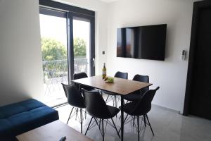 a dining room with a table and chairs at Elite estate in Podstrana