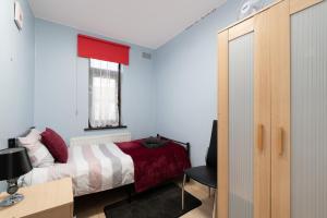 a bedroom with a bed and a desk and a window at Excel 5min CUSTOM HOUSE STATION parking WIFI sleeps 6 in London