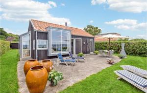 a house with large windows and a patio at Amazing Home In Nyborg With Kitchen in Nyborg