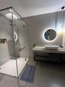 a bathroom with a sink and a glass shower at Hotel,Căn Hộ Mũi Né Sea link in Phan Thiet