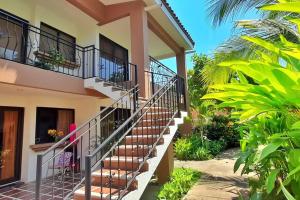 a woman sitting on a chair in front of a house at Jade Beach B apartamento 20 in Coco