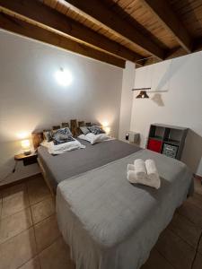 a bedroom with two beds with towels on them at Villa au calme avec Jacuzzi, Villa Le Boursoie in Les Abymes