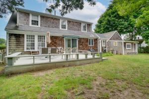 a house with a large deck with chairs on it at 1 Mi to Marina Hyannis Home with Furnished Deck in Hyannis