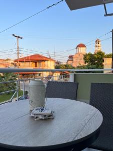 a coffee cup sitting on a table on a balcony at Utopia.luxuryapartment in Nea Potidaea +1 photo