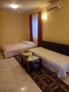 a hotel room with two beds and a table at Nafija in Donji Štoj