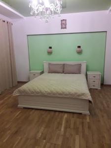 a bedroom with a bed with a green wall at MODEST in Slavske