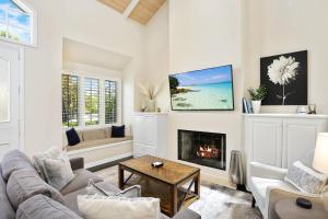 a living room with a couch and a fireplace at 416 Dahlia in Newport Beach