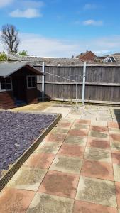 a yard with a wooden fence and a patio at Comfortable Family Home in Immingham in Immingham