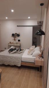 a bedroom with a bed and a black lamp at Garden Suite Apartment in Palermo