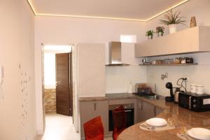 a kitchen with white cabinets and a counter top at Apartment Amber Rijeka in Rijeka