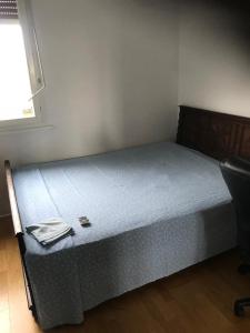 a bed in a room with a blue mattress at Beauvais chambre 1 in Beauvais
