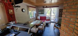 a living room with a table and a couch at Domek u Majki in Tylmanowa