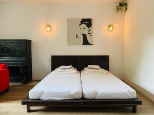 two twin beds in a room with avertisement for at SPOKO Hostel in Gdańsk
