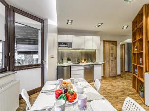 a kitchen with a table with fruits and vegetables on it at VisitZakopane - White Valley Apartment in Zakopane