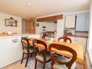 a kitchen and dining room with a wooden table and chairs at 9 Bell Busk in Skipton